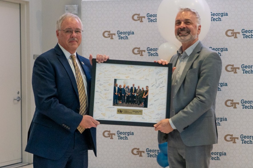 Baker poses with the guest speakers at his retirement ceremony.